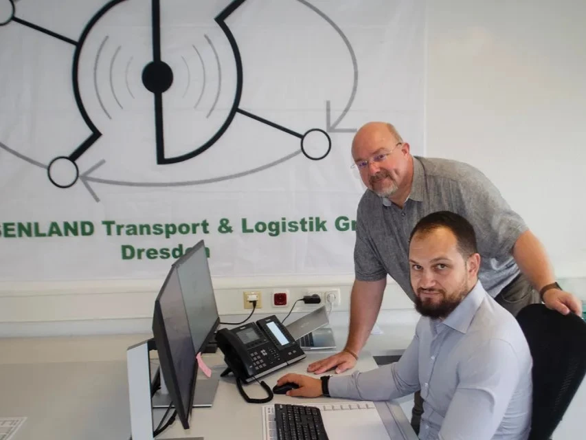 Logistics coordinator with shipment tracking on screen